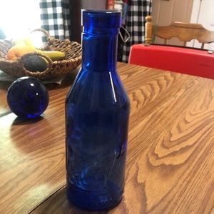 Cobalt blue milk pitcher with embossed cow.